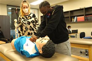 Man practicing resuscitation on a dummy 